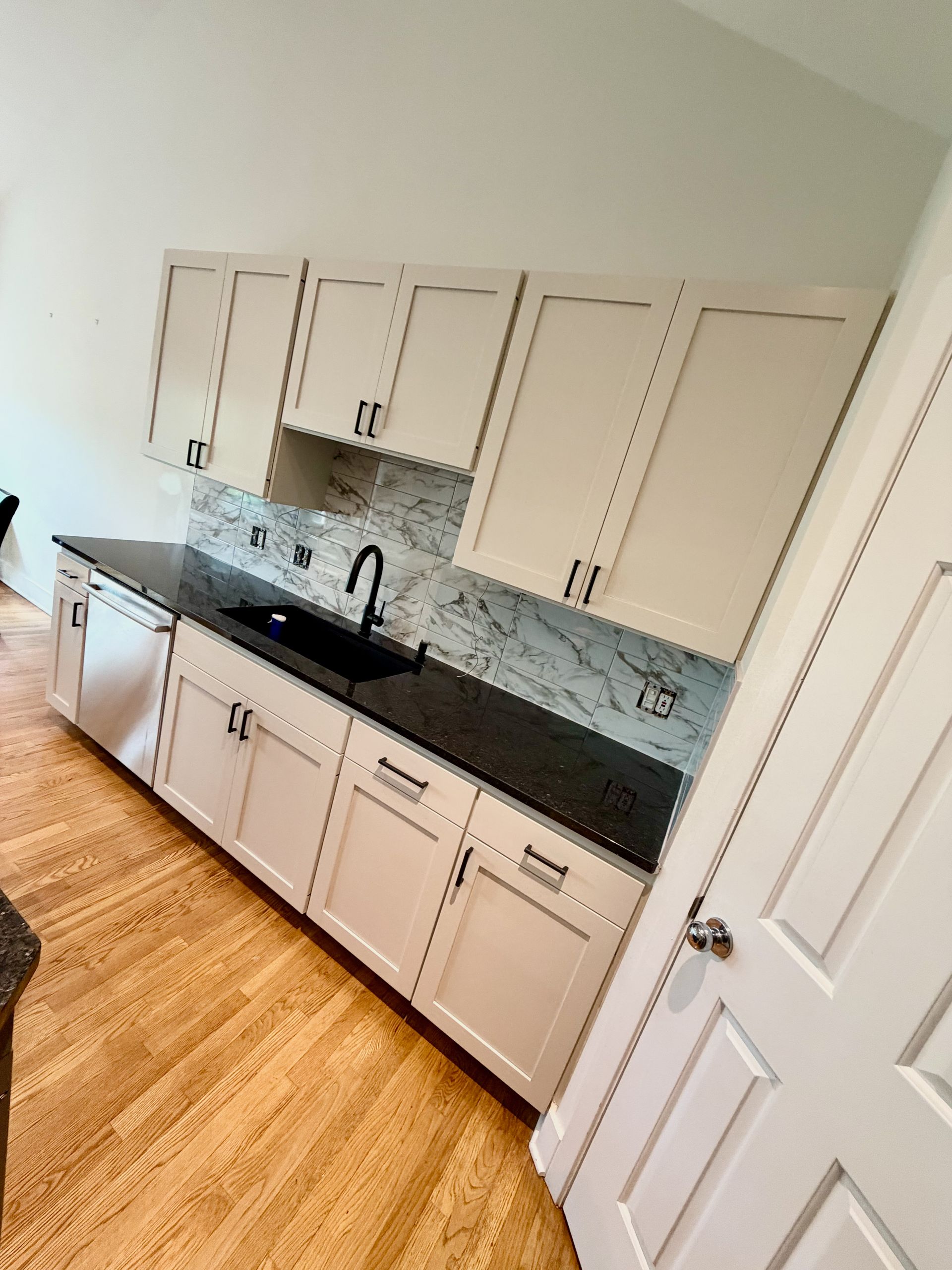 Westlake Hills kitchen after cabinet painting with new tile backsplash hardware and Seapearl walls