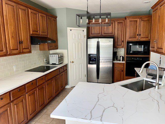 A kitchen with stainless steel appliances and wooden cabinets