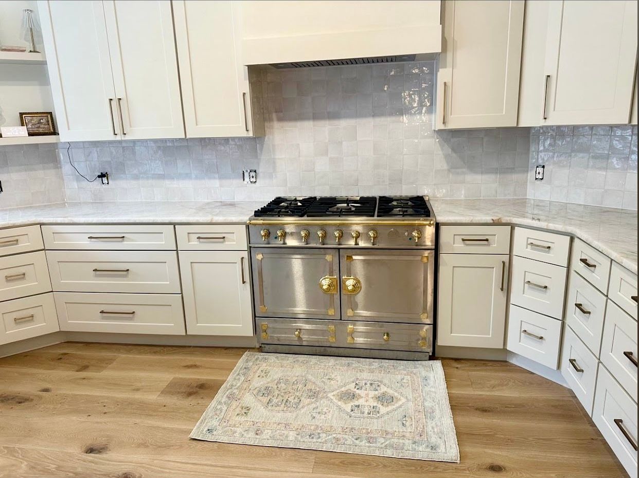 Austin kitchen remodel in River Place with custom vent hood quartzite countertops and interior painting