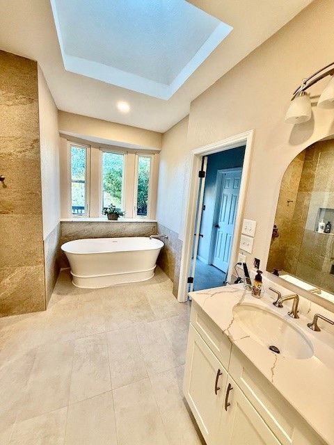 Freestanding tub and modern tile design in Cedar Park bathroom remodel