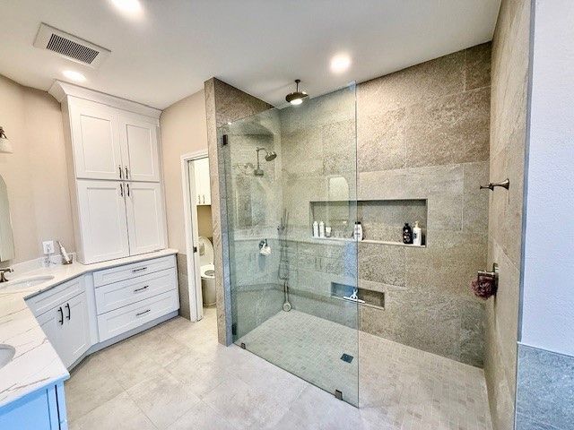 Bathroom remodel in Austin TX with quartz countertops custom vanity and curbless walk in shower