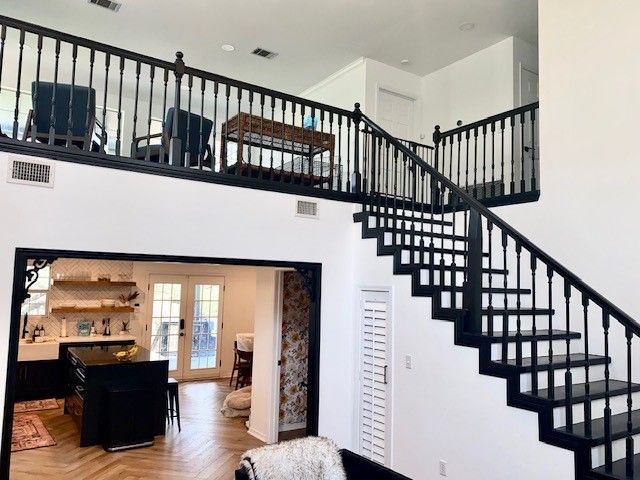 Austin interior painting project with black staircase railing and white walls