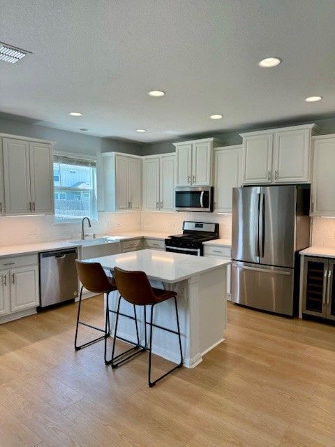 Home in the south Austin, TX with full kitchen remodel including cabinet painting, new countertops, and new backsplash completed by Austin Painting and Cabinets