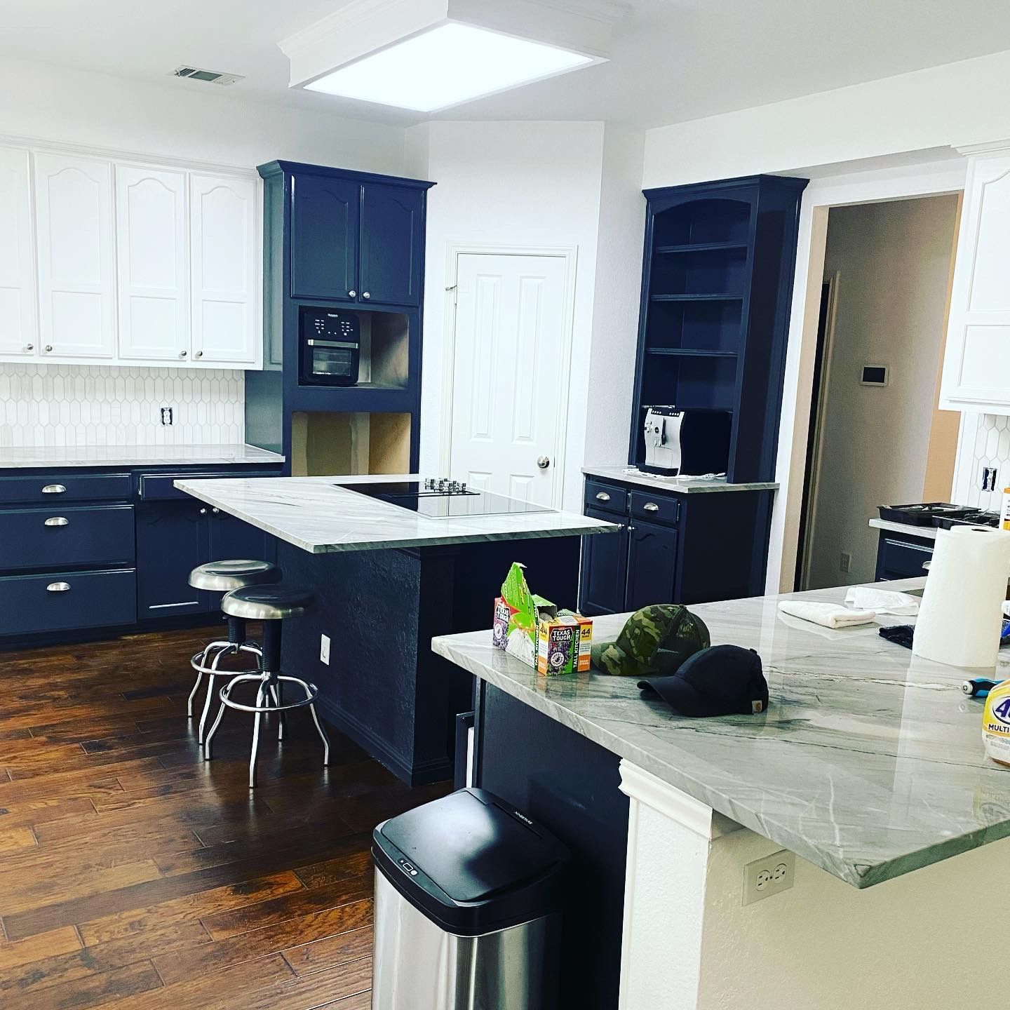 Kitchen remodel in Lakeway featuring painted cabinets quartzite countertops and tile backsplash