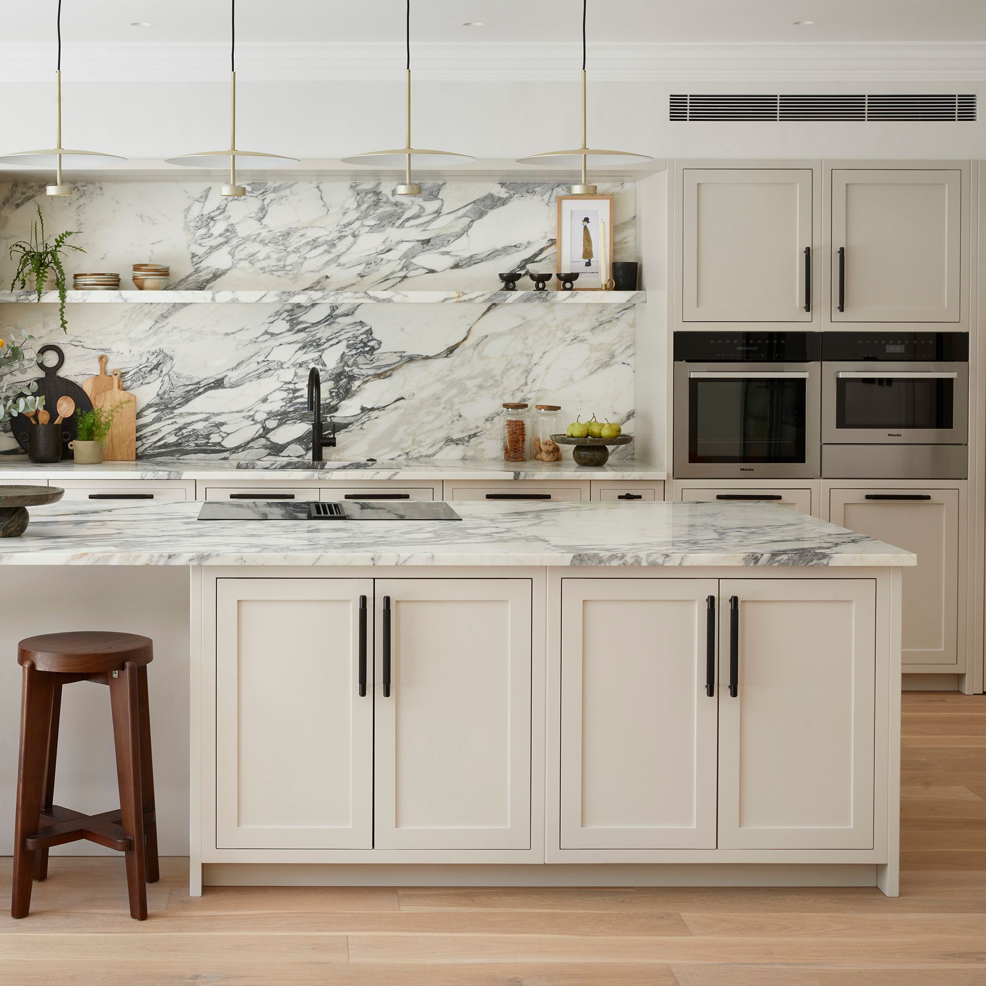 Slim shaker kitchen cabinets in an Austin kitchen remodel with bright countertops and modern hardware