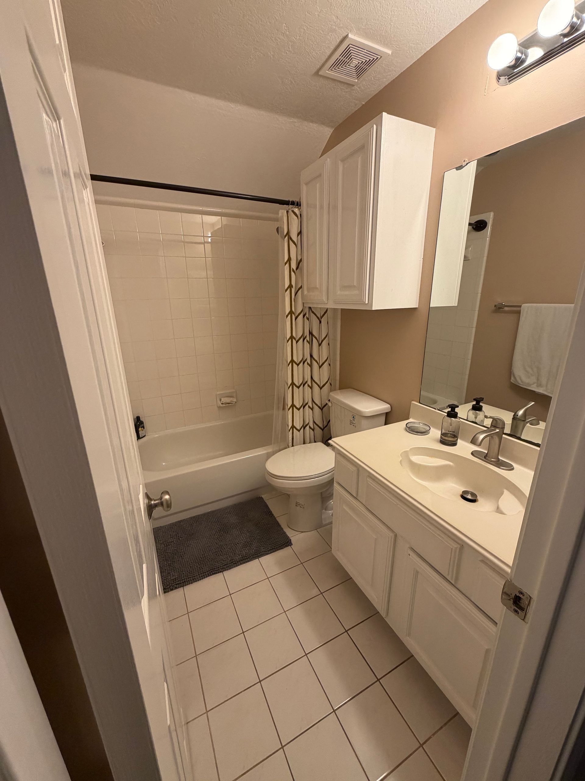 Before photo of Northwest Austin guest bathroom remodel with outdated tub and shower area