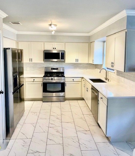 Northwest Austin kitchen remodel with cabinet refacing shaker doors quartz countertops and backsplas