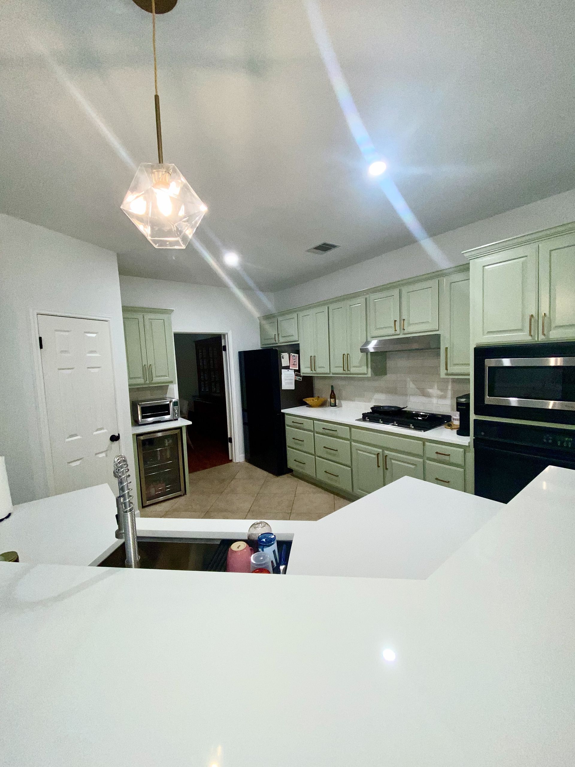 Austin kitchen remodel with Clary Sage cabinets Arizona Tile Flash Ivory backsplash and pendant lighting