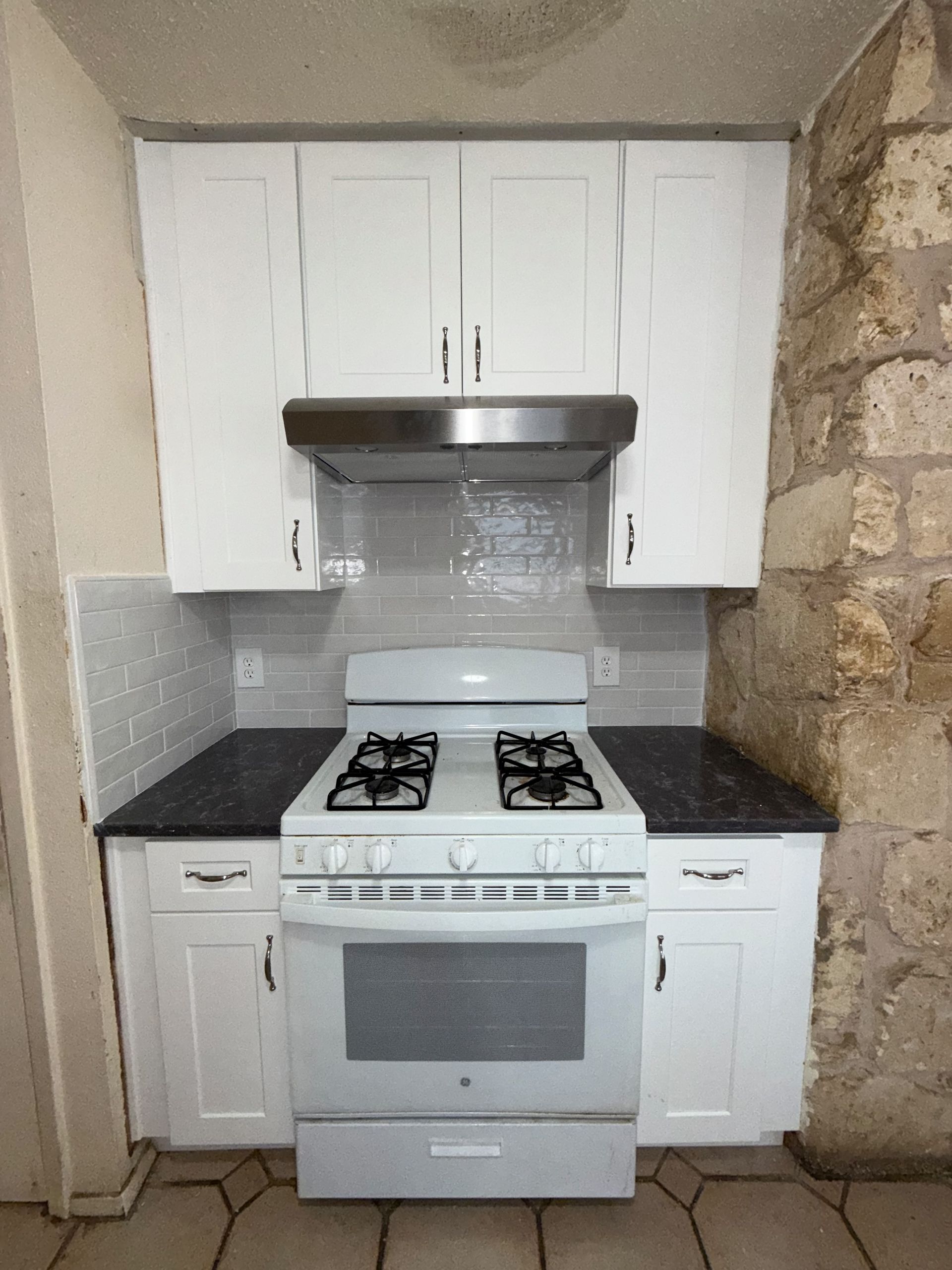 After South Austin kitchen remodel with taller new cabinets quartz countertops tile backsplash and new sink