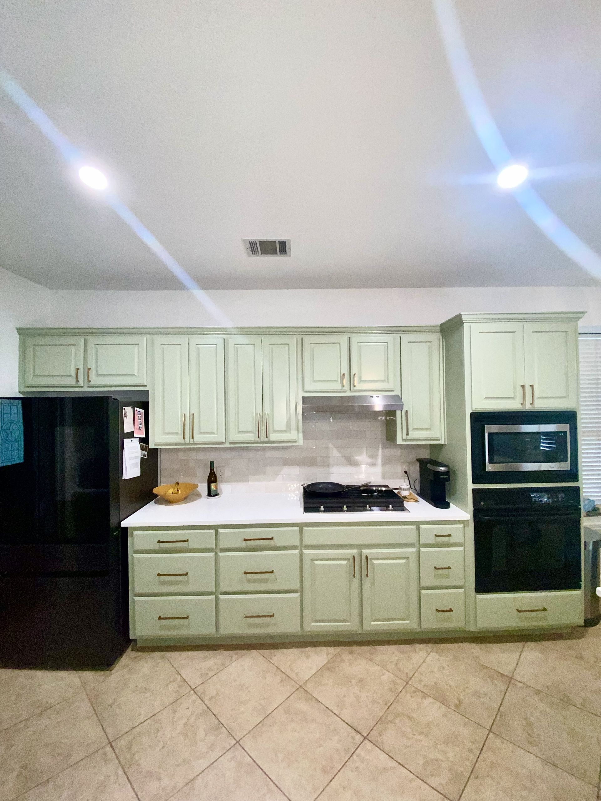South Austin kitchen remodel with Sherwin-Williams Clary Sage cabinets MSI Arctic White quartz 