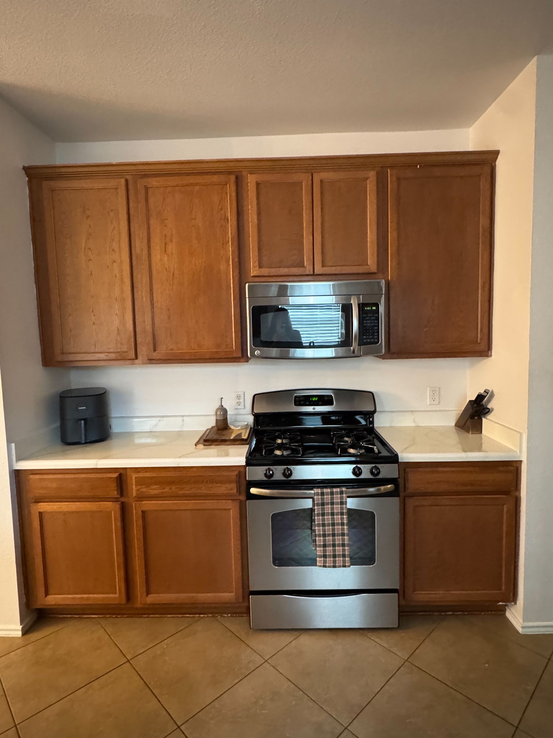 South Austin kitchen before cabinet painting, quartz countertops, and flooring replacement