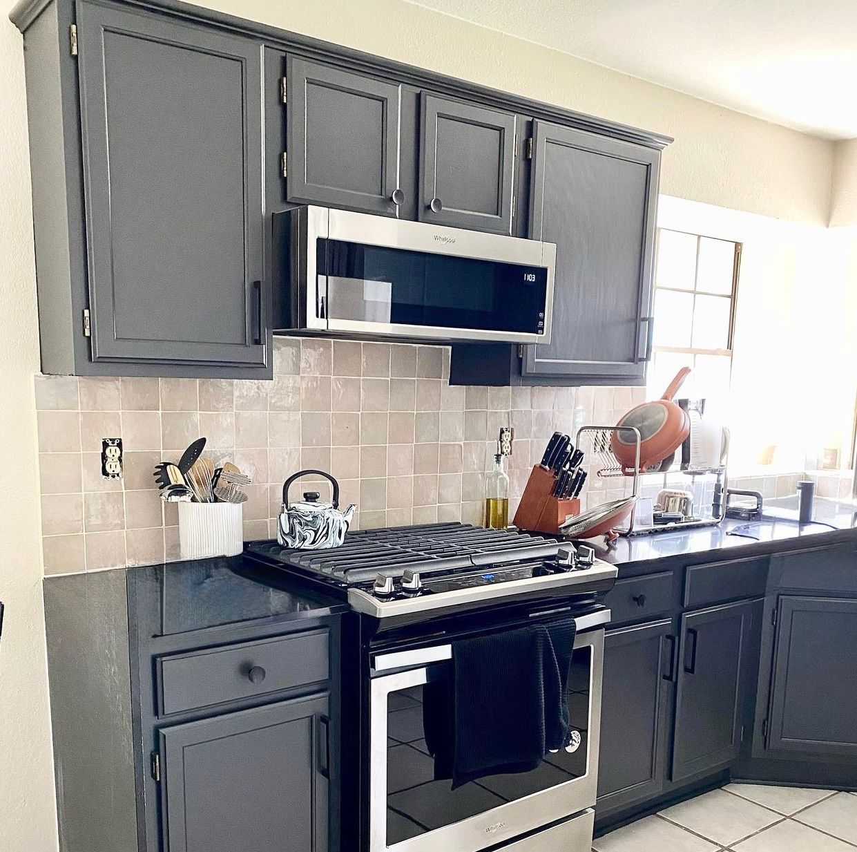 Wells Branch Austin kitchen remodel with cabinet painting waterfall quartz countertops and tile back