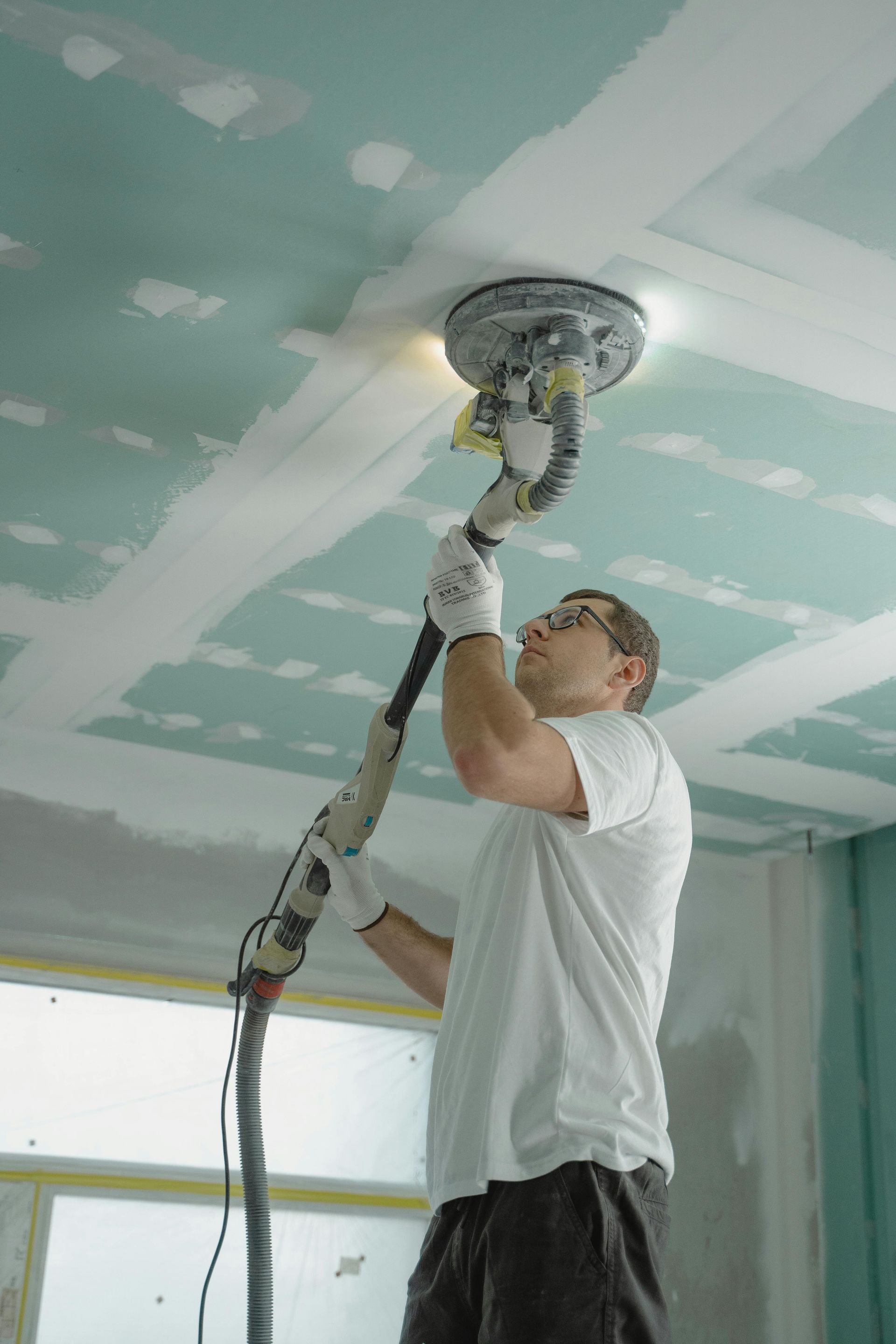 Drywall repair being completed to home in Lago Vista, TX by the best painting contractor Austin Painting and Cabinets