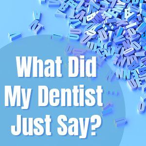 A pile of letters on a blue background with the words what did my dentist just say