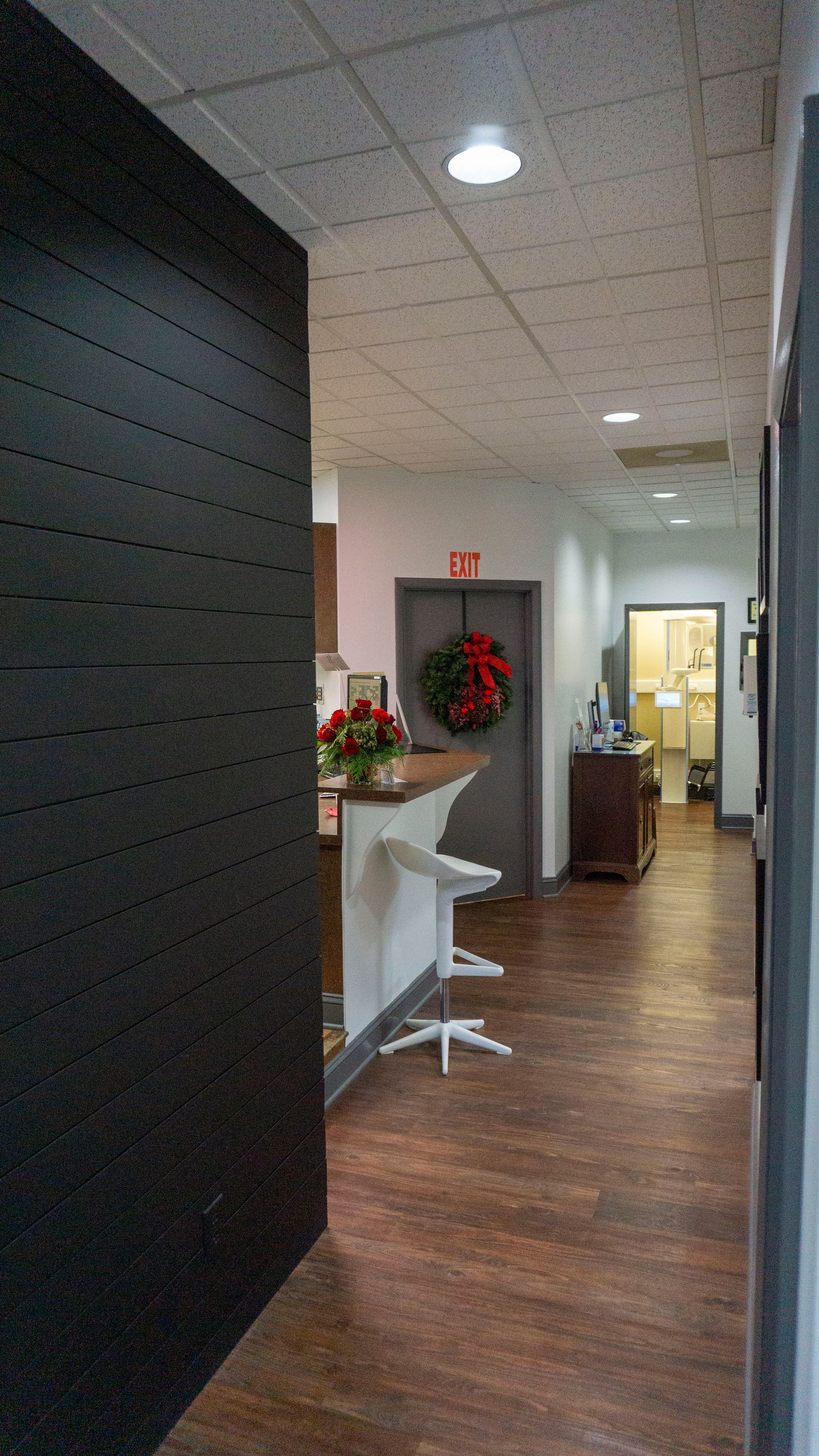 A hallway in a building with a wreath on the door.