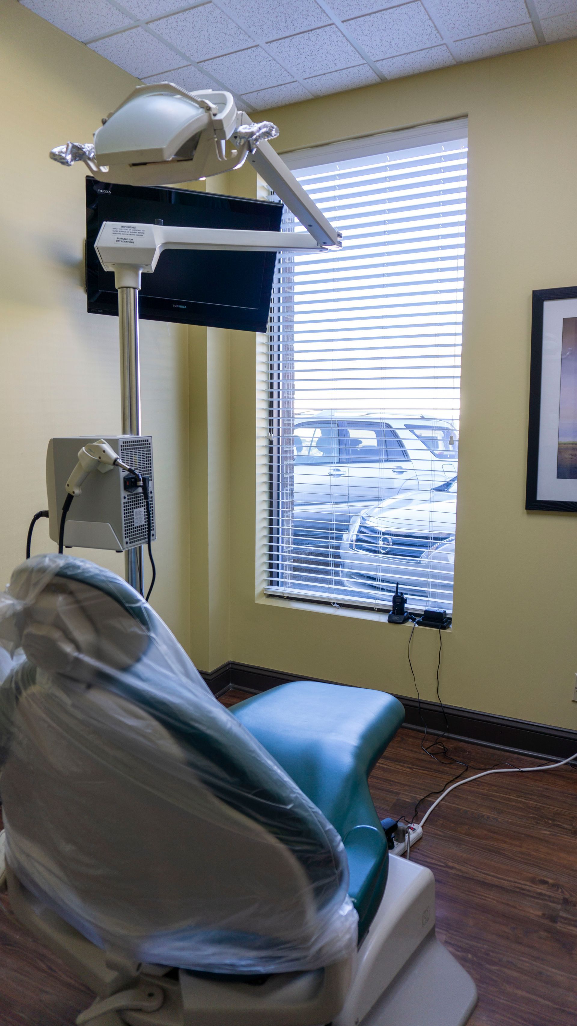 A dental office with a dental chair and a window