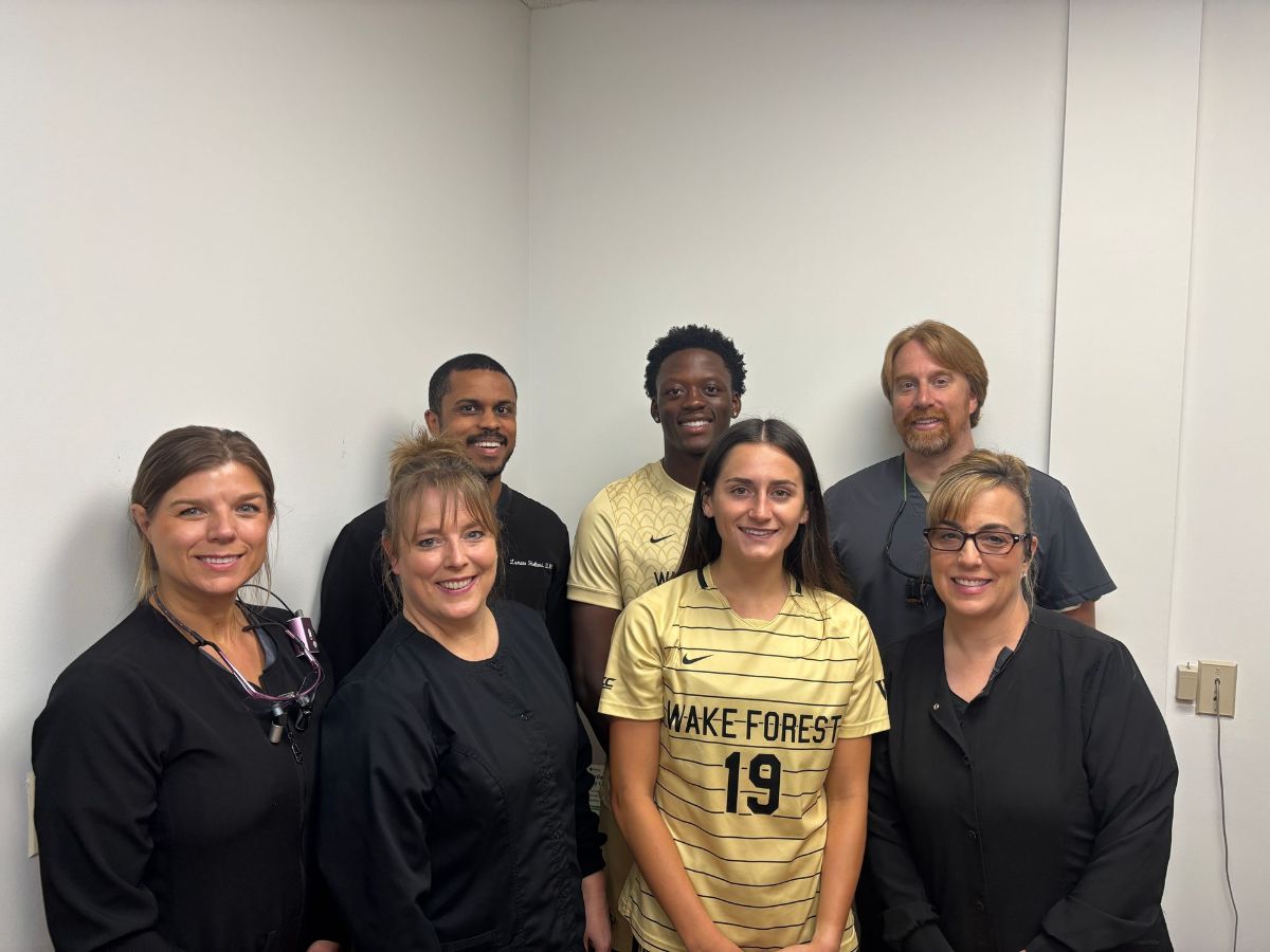 A group of people are posing for a picture in a room.