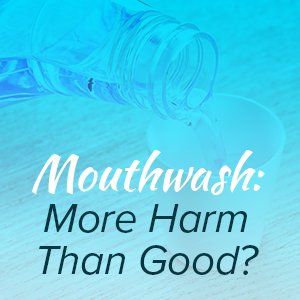 A bottle of mouthwash is being poured into a cup