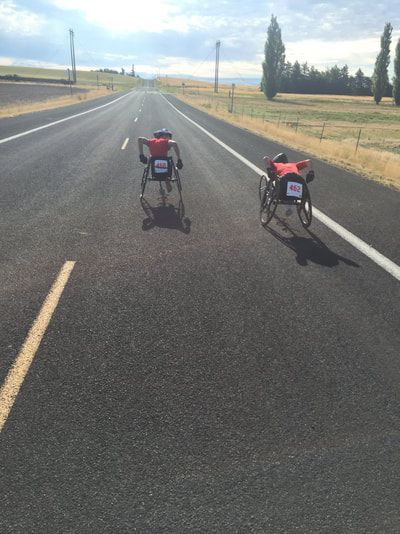 Two racers push far down a straight rural highway