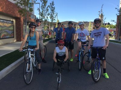 Racer poses with a group of cyclists on a city street