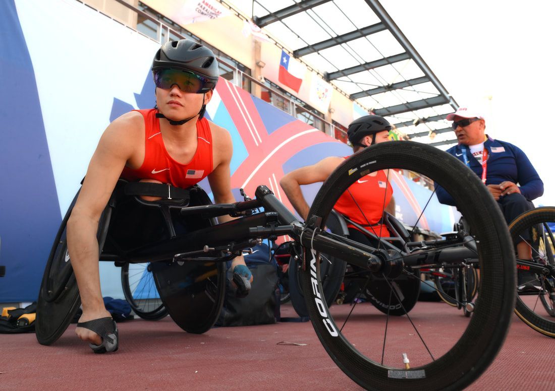 Phillip Croft in a red Team USA top settles into his racing chair