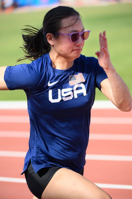 Taylor Swanson in purple sunglasses drives her arms, close up