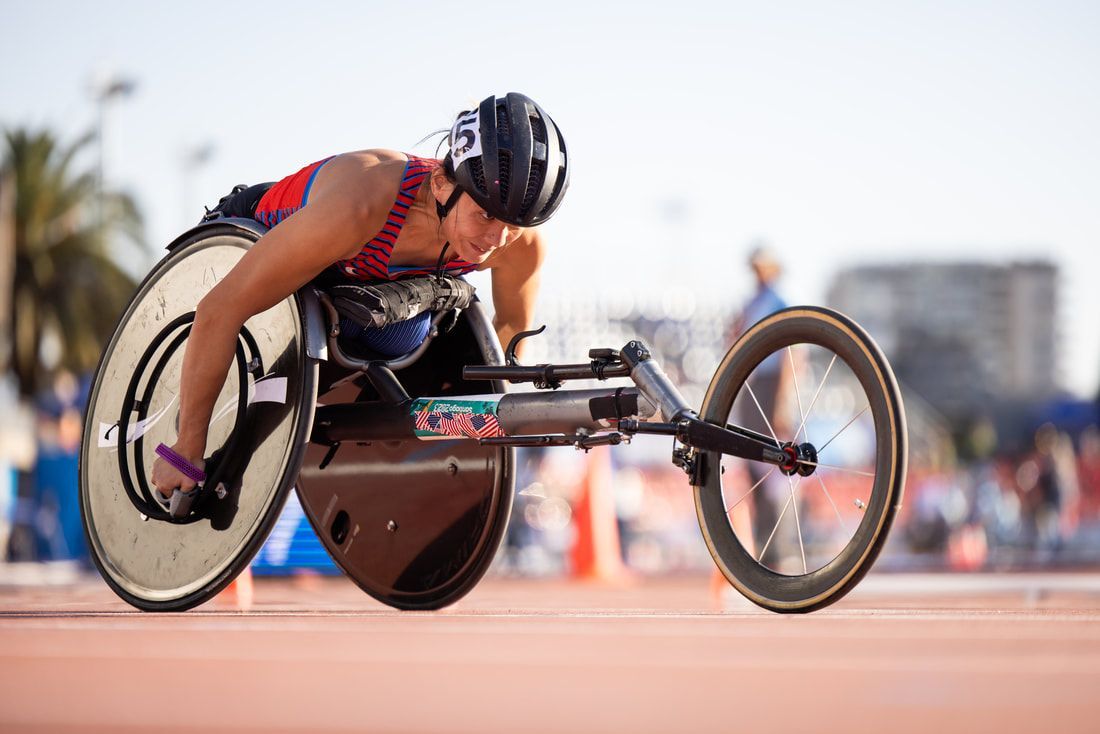 Hannah Dederick rounds the curve in her racing wheelchair