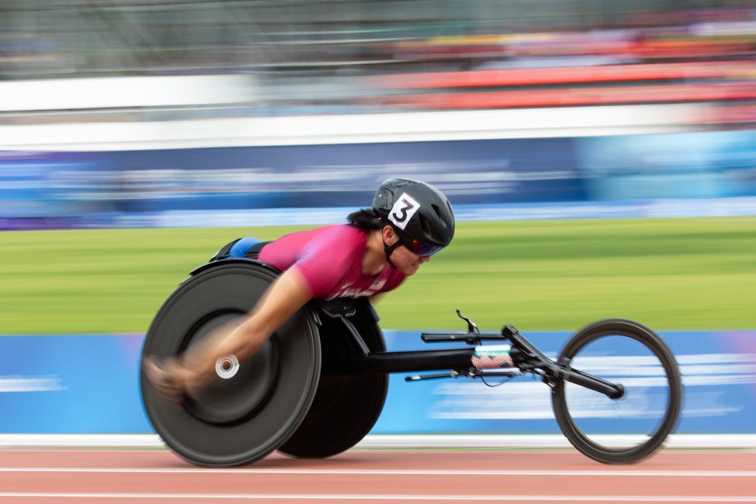 Phillip Croft, helmet number 3, speeds past in a maroon USA top