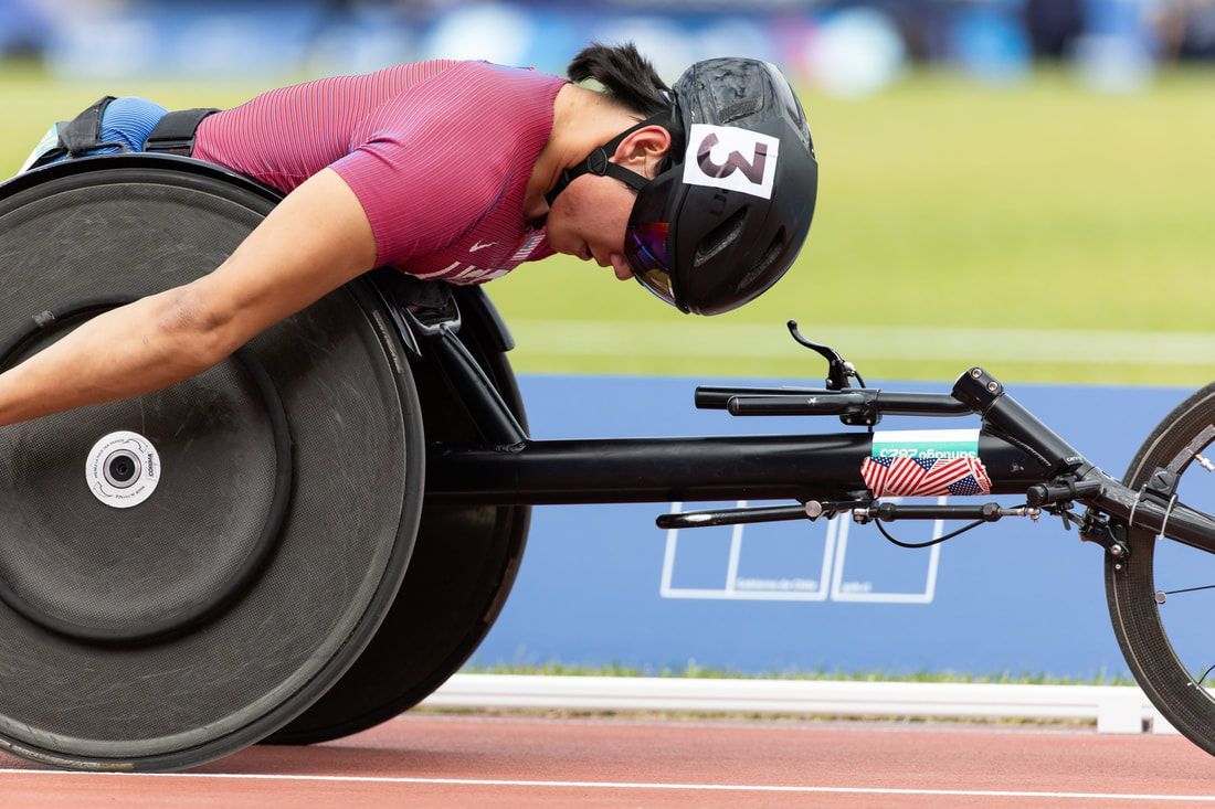 Phillip Croft, helmet number 3, leans low over his racing chair