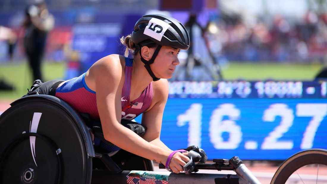 Hannah Dederick in her racing wheelchair by a 16.27 time on the 100m board