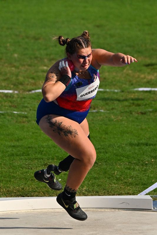 Team USA shot putter drives across the circle with the shot at her neck