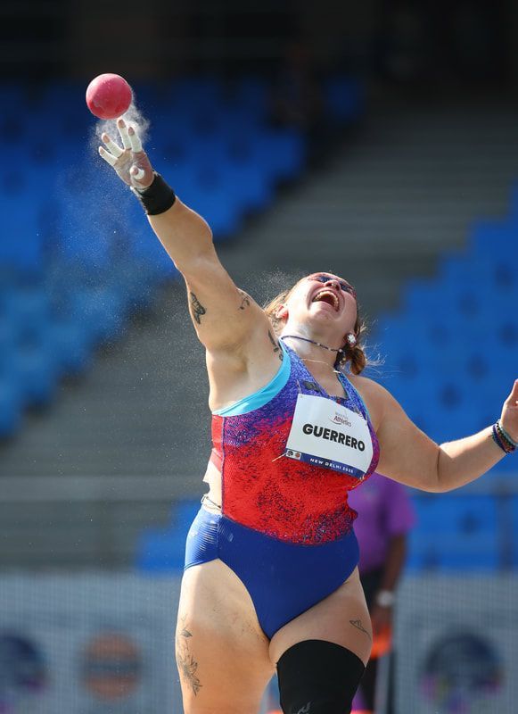 Team USA shot putter releases the shot in a burst of chalk dust
