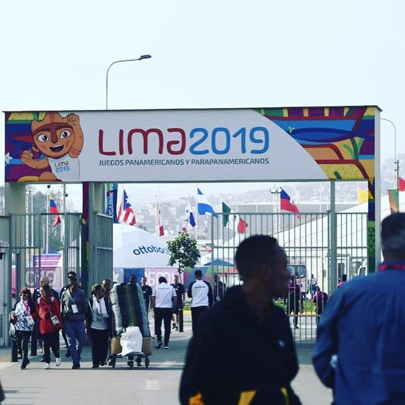Visitors walk under the Lima 2019 Parapan American Games entrance arch