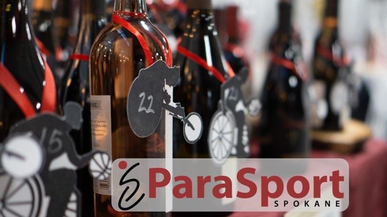Wine bottles with numbered wheelchair athlete tags and the ParaSport logo