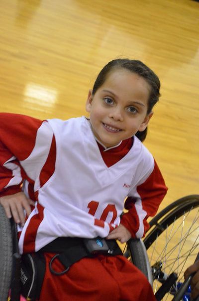 Smiling young player in a white and red jersey 10 on the court
