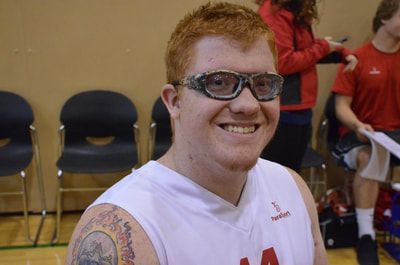 Smiling player with sports goggles in a white ParaSport jersey