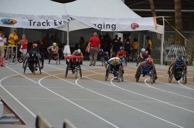 Wheelchair racers gather under the Track Event Staging tent