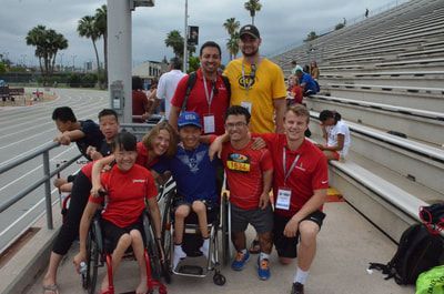 ParaSport Spokane athletes and coaches pose together by the stadium stands