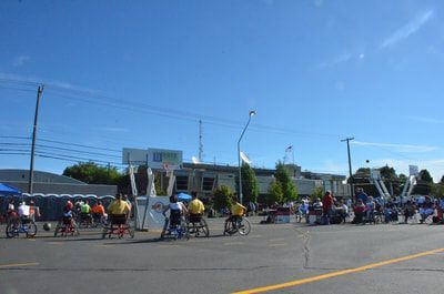 Wide view of the Hoopfest wheelchair court under a clear blue sky