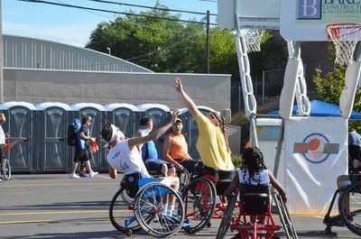 Players stretch for a rebound under the hoop at Hoopfest 2018