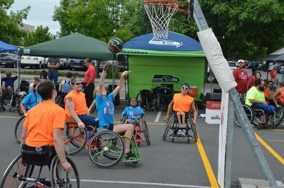Shot sails toward the hoop as players in orange and light blue look up