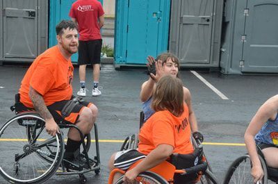 Players high-five after a game while a smiling player in orange looks on