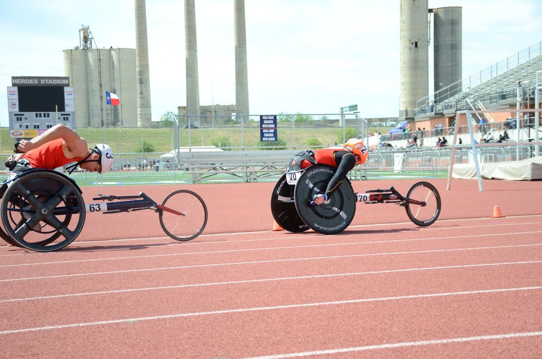Two wheelchair racers on the track at Heroes Stadium in San Antonio