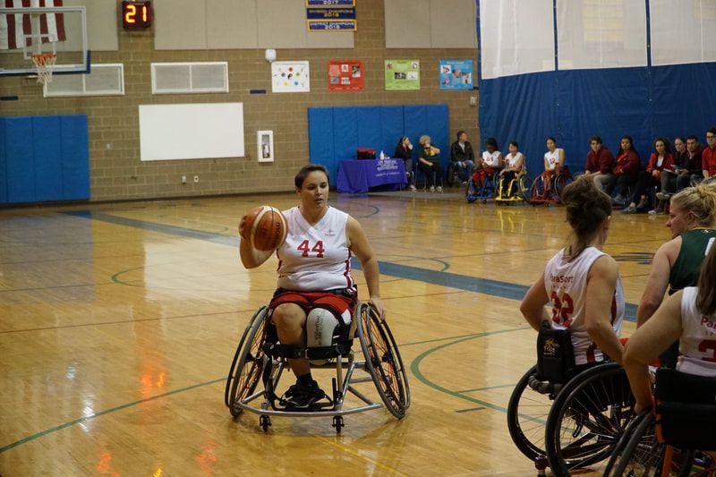 Player #44 in white dribbles up court as players in green trail