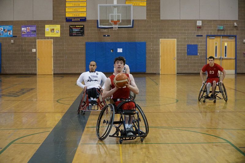 Player in red brings the ball up court as #23 in red trails