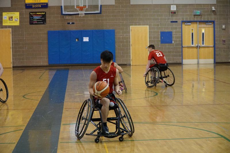 Player #51 in red dribbles up court as teammate #23 follows