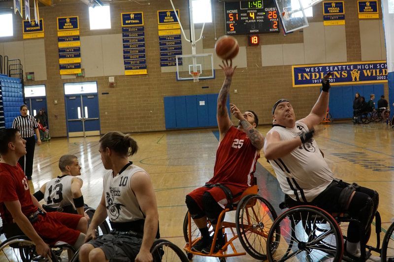 Player #25 in red puts up a shot as a defender in white reaches high
