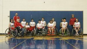 Wheelchair basketball team in white jerseys at the 2014 Salem Tournament