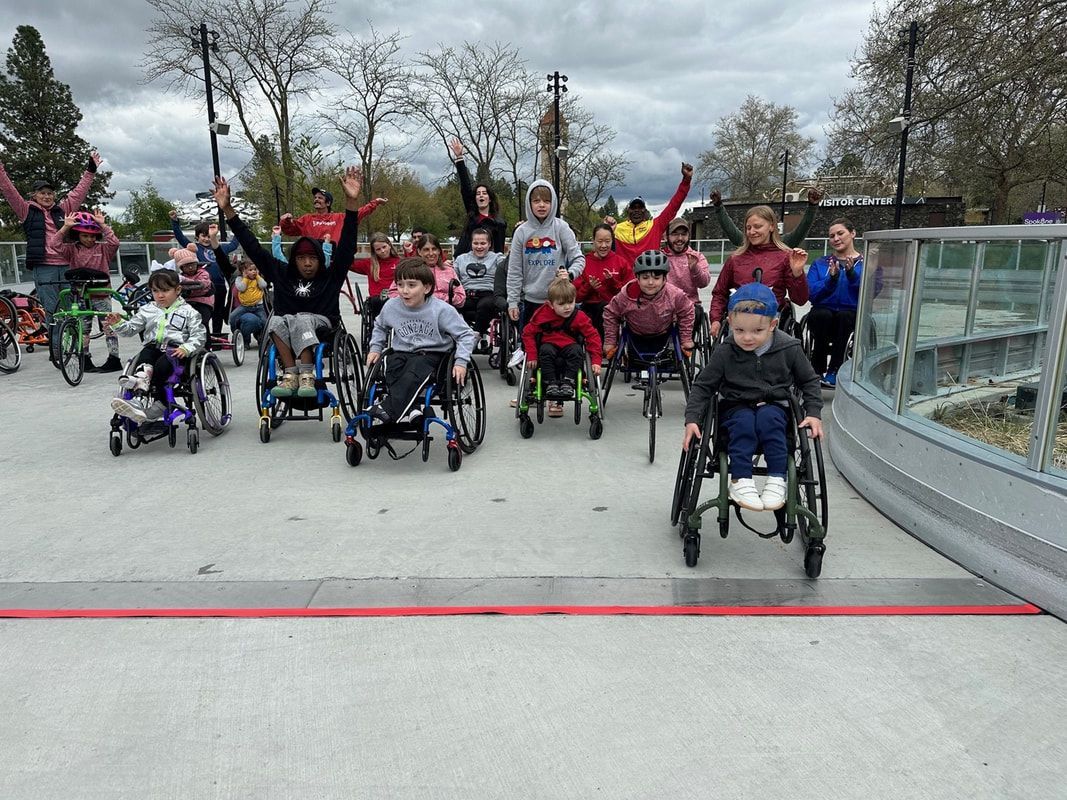 Cheering young racers in wheelchairs and on adaptive bikes at Future Bloomies