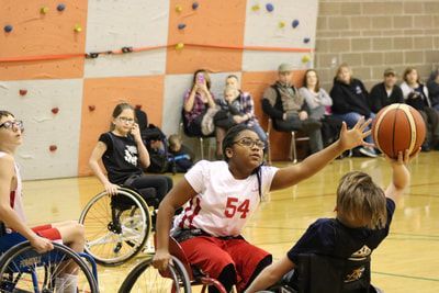 Player in jersey 54 reaches for a rebound against an opponent in navy